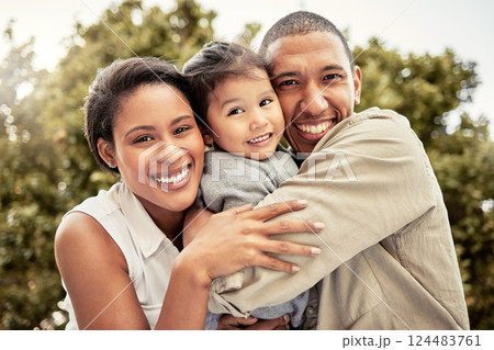 Hug, child and parents with smile in a park for love, care and adventure on a holiday in Maldives. Happy, travel and portrait of mother and father hugging kid while on vacation in a nature garden 124483761