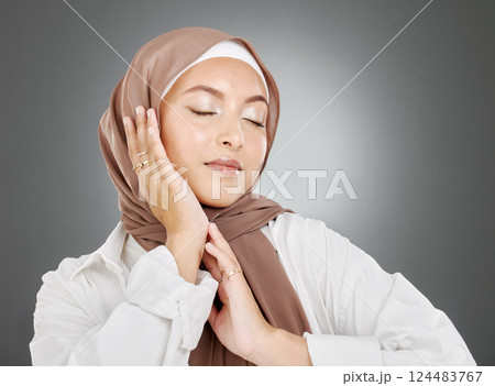 Beauty, muslim and woman with hand pose for natural makeup marketing with satisfied and pretty face. Hijab, islamic and beautiful cosmetic model posing for advertising with grey studio mockup. Beauty, muslim and woman with hand pose for natural makeup marketing with satisfied and pretty face. Hijab, islamic and beautiful cosmetic model posing for advertising with grey studio mockup. 124483767