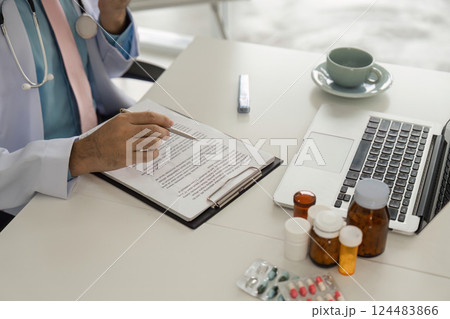 Medical Consultation and Patient Care. A healthcare provider carefully records patient information during a telehealth session. Medical Consultation and Patient Care. A healthcare provider carefully records patient information during a telehealth session. 124483866