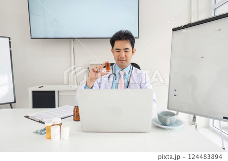 Telemedicine and Consultations. A doctor discussing treatment options remotely while observing medication. Telemedicine and Consultations. A doctor discussing treatment options remotely while observing medication. 124483894