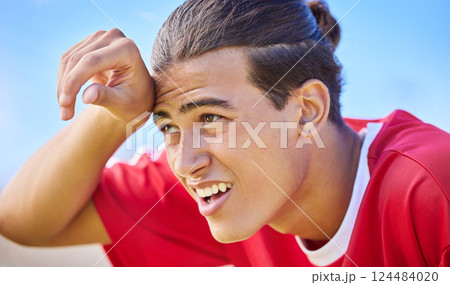 Soccer, sports and sweat with a tired man outdoor for a competitive game or match during the day. Football, fitness and health with a soccer play outside for exercise, a workout or competitive sport 124484020