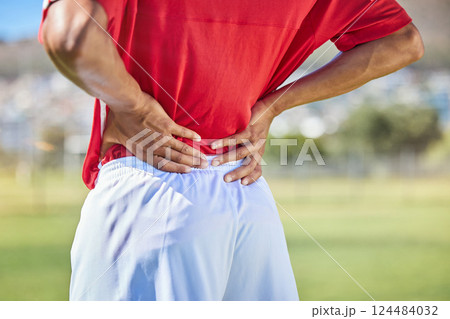 Field, soccer and man with back injury in game tournament with pain, inflammation and backache. Football, athlete and accident in match with player holding body muscle for pressure relief. 124484032