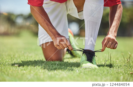 Hands, shoes and soccer player at a soccer field, tie lace and prepare for training, sports and fitness game. Football, hand and football player getting ready for workout, exercise and sport practice Hands, shoes and soccer player at a soccer field, tie lace and prepare for training, sports and fitness game. Football, hand and football player getting ready for workout, exercise and sport practice 124484054