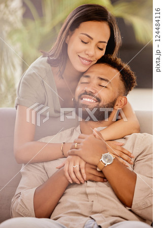 Couple, man and black woman on sofa for hug, love and care in living room to relax while happy. Black man, woman and marriage for romance, embrace and smile together on couch in lounge with happiness Couple, man and black woman on sofa for hug, love and care in living room to relax while happy. Black man, woman and marriage for romance, embrace and smile together on couch in lounge with happiness 124484116