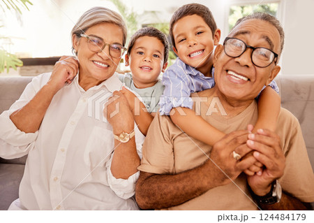 Love, happy family and kids relax with grandparents on a sofa, hug and bonding in a living room. Portrait, seniors and children embracing, laughing and enjoying visit to grandma and pa on the weekend Love, happy family and kids relax with grandparents on a sofa, hug and bonding in a living room. Portrait, seniors and children embracing, laughing and enjoying visit to grandma and pa on the weekend 124484179