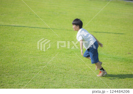 芝生の広場を走る男の子　 124484206