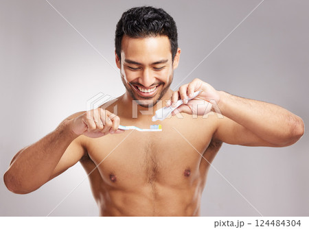Studio, man and toothpaste with brush for dental, hygiene and wellness with happiness for self care. Smile, male person and model with oral product for gum health, teeth whitening and gray background Studio, man and toothpaste with brush for dental, hygiene and wellness with happiness for self care. Smile, male person and model with oral product for gum health, teeth whitening and gray background 124484304
