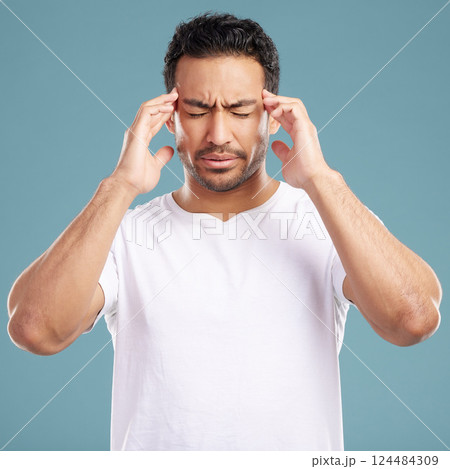 Headache, stress and man in studio with anxiety, burnout or frustrated by brain fog on blue background. Vertigo, face and male model with temple massage for pain, migraine or tension or strain Headache, stress and man in studio with anxiety, burnout or frustrated by brain fog on blue background. Vertigo, face and male model with temple massage for pain, migraine or tension or strain 124484309