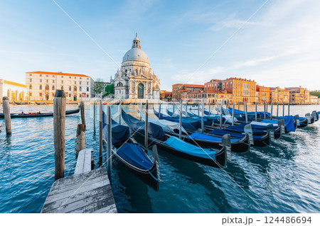 Venetian gondolas moored at dawn, Basilica backdrop. Venetian gondolas moored at dawn, Basilica backdrop. 124486694
