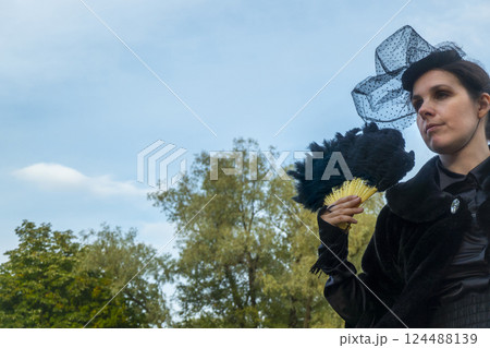A women in vintage clothes on a walk in the park. A women in vintage clothes on a walk in the park. 124488139