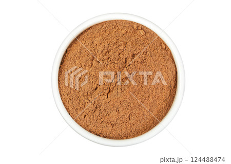Cinnamon powder in ceramic bowl isolated on white background. Top view. Flat lay Cinnamon powder in ceramic bowl isolated on white background. Top view. Flat lay 124488474