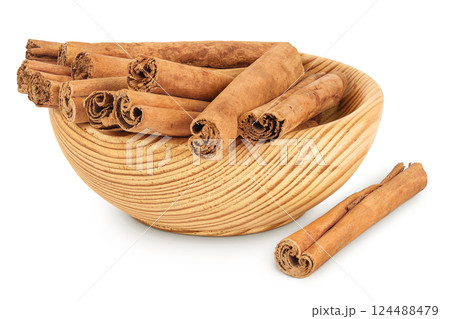 Cinnamon sticks in wooden bowl isolated on white background with full depth of field. Cinnamon sticks in wooden bowl isolated on white background with full depth of field. 124488479
