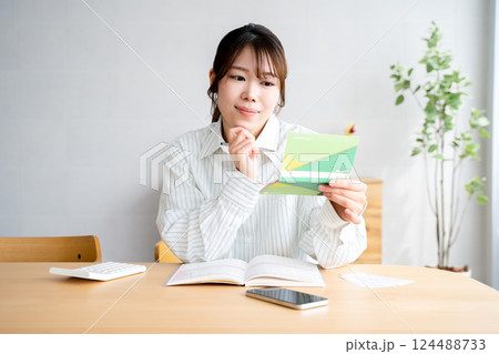 家計簿をつける女性 124488733