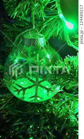 Christmas tree decorated with beautiful transparent ball with abstract snowflake Christmas tree decorated with beautiful transparent ball with abstract snowflake 124489217