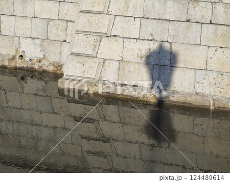 shadow of a city lamp on the fortress wall shadow of a city lamp on the fortress wall 124489614