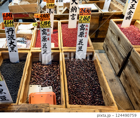 Various types of dried beans including black red and speckled varieties displayed in wooden crate 124490759