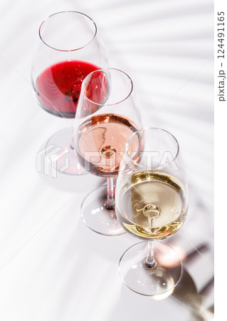 Three wine glasses filled with red, white, and rose wine 124491165