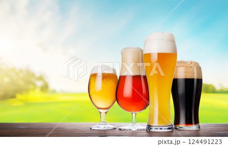 An assortment of beer glasses filled with different types of beer An assortment of beer glasses filled with different types of beer 124491223