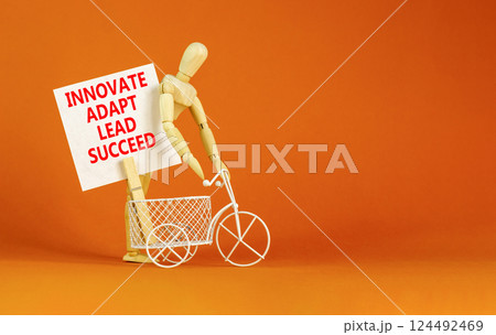 Innovate adapt lead succeed symbol. Concept words Innovate Adapt Lead Succeed on beautiful white paper. Beautiful orange background. Business innovate adapt lead succeed concept. Copy space. 124492469