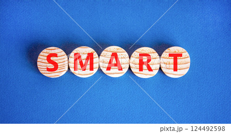 Smart symbol. Concept word Smart on beautiful wooden circles. Beautiful blue table blue background. Business lifestyle smart concept. Copy space. Smart symbol. Concept word Smart on beautiful wooden circles. Beautiful blue table blue background. Business lifestyle smart concept. Copy space. 124492598