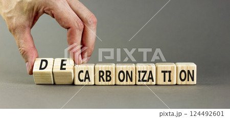 Decarbonization or carbonization symbol. Concept words Decarbonization or Carbonization on wooden blocks. Beautiful grey background. Business decarbonization or carbonization concept. Copy space. 124492601
