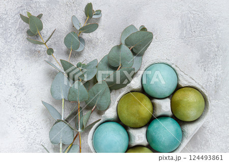 Easter colored eggs, in green and turquoise tones, with eucalyptus leaves, Easter card, top view, no people, Easter colored eggs, in green and turquoise tones, with eucalyptus leaves, Easter card, top view, no people, 124493861