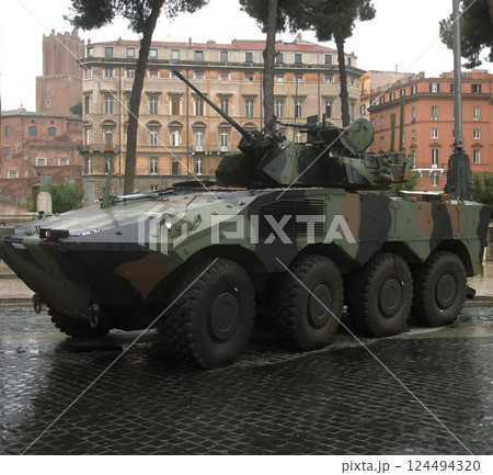 Armored Military Vehicle Parked on City Street 124494320