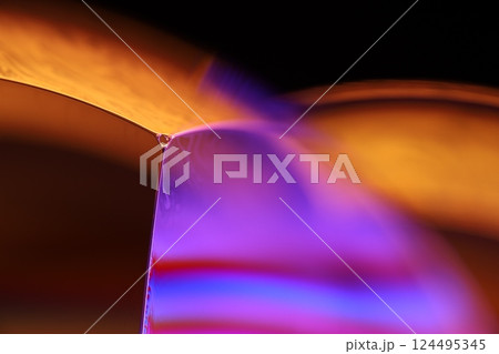 Orange and purple liquid texture in macro, bright fluid, bubbles in macro, dark background, copy space, perfect water edges 124495345
