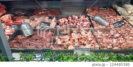 Display case with meat products. Close-up of chicken giblets in large quantities. 124495380
