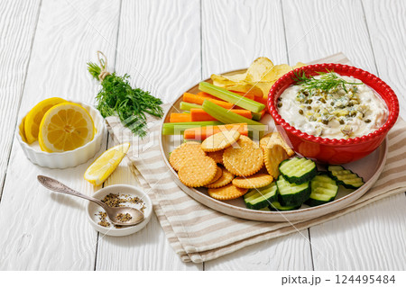 creamy yogurt pickles caper dill dip in red bowl 124495484