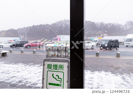 降雪の高速道路常磐道上り水戸四倉SA喫煙所案内板 124496728