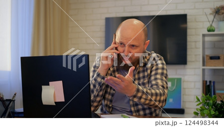Man balancing work calls and personal conversations, balance evident in multitasking, balance essential for remote work efficiency, perfect for lifestyle and business content. Man balancing work calls and personal conversations, balance evident in multitasking, balance essential for remote work efficiency, perfect for lifestyle and business content. 124498344