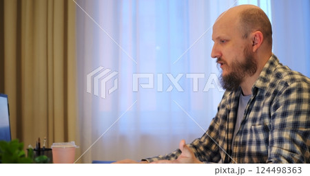 Man implements new software to spur progress, trusting progress for modern office tasks, aiming for progress that streamlines operations and elevates overall workflow. Remote work of man at computer 124498363