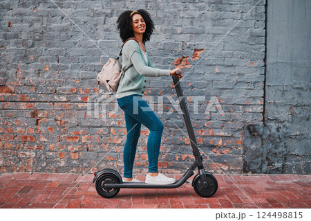 Black woman, electric and scooter in city with smile, happy and relax for summer day, edgy and trendy on sidewalk. Yong female, girl and eco friendly transportation have fun, cheerful and in street. Black woman, electric and scooter in city with smile, happy and relax for summer day, edgy and trendy on sidewalk. Yong female, girl and eco friendly transportation have fun, cheerful and in street. 124498815