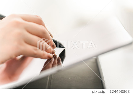 タブレットPCにペンタブを使って何かを描く女性(漫画家・クリエイター・デザイナー・アニメーター) 124498868