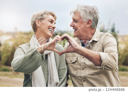 Love, heart sign and senior couple with marriage happiness, healthy and wellness lifestyle in countryside. Elderly people man, and woman with loving hands in park or nature retirement holiday 124498886