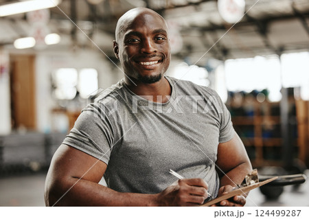 Gym, documents or black man writing on clipboard for membership, sign up or checklist for sport health or workout. Wellness coach, fitness or happy personal trainer, paper for exercise schedule Gym, documents or black man writing on clipboard for membership, sign up or checklist for sport health or workout. Wellness coach, fitness or happy personal trainer, paper for exercise schedule 124499287