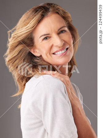 Skincare, beauty and portrait of senior woman with confidence, natural beauty and smile. Old woman posing for anti aging beauty products, dermatology care and skin wellness on gray background studio 124499439