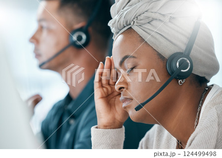 Headset, call center and black woman with headache, stress and anxious being overworked in office. Frustrated, customer support agent and burnout with depression, pain and migraine sitting at desk. Headset, call center and black woman with headache, stress and anxious being overworked in office. Frustrated, customer support agent and burnout with depression, pain and migraine sitting at desk. 124499498