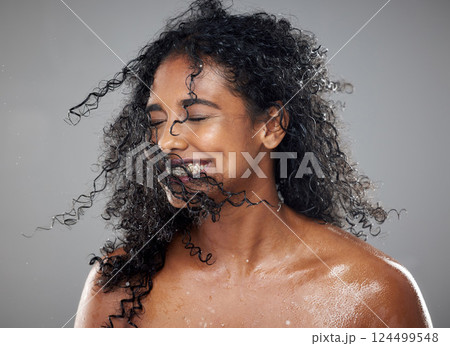 Healthy, wet hair and skincare beauty of a black woman with cosmetics product mockup to hydrate, nourish and moisturize African hair. Clean skin health, cosmetics treatment and gray studio background Healthy, wet hair and skincare beauty of a black woman with cosmetics product mockup to hydrate, nourish and moisturize African hair. Clean skin health, cosmetics treatment and gray studio background 124499548