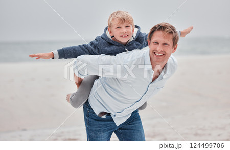 Family, portrait and airplane game by father and child at a beach, playing and having fun on a sea vacation. Happy family, children and fly with parent and son bonding, relax and enjoying ocean trip 124499706