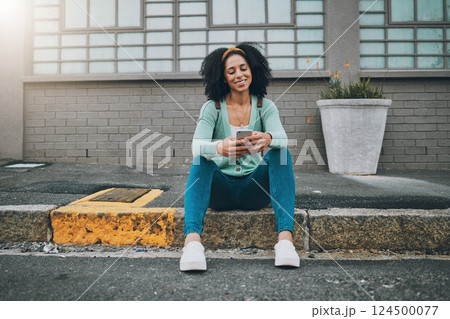 Black woman, city sidewalk and smartphone in hand scroll social media smile sitting on the street pavement. Happy woman, texting on phone and using 5g mobile network for outdoor online communication Black woman, city sidewalk and smartphone in hand scroll social media smile sitting on the street pavement. Happy woman, texting on phone and using 5g mobile network for outdoor online communication 124500077
