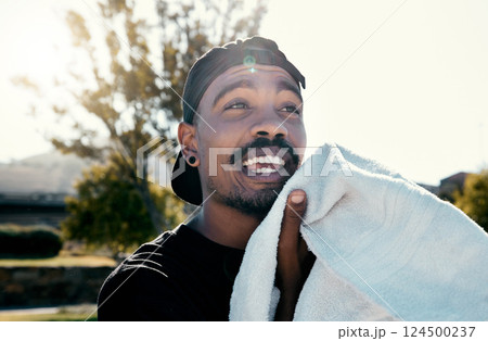 Black man, face and towel while outdoor for fitness, health and exercise in park, street or town. Man, young and gen z in summer, sunshine or trees with cloth for dry, sweat or skin in Los Angeles 124500237