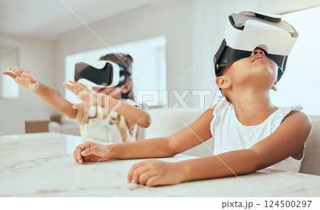 Vr, technology and children in their home, playing with headset on streaming videos, games and metaverse ux. Tech, 3d and kids with virtual reality goggles on for movies, gaming and futuristic fun 124500297