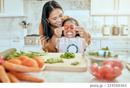 Mother, child and have fun cooking in kitchen together with teamwork to cut chillies, peppers and vegetables on counter for lunch. Happy, girl with smile and mom teach kid healthy food recipe at home Mother, child and have fun cooking in kitchen together with teamwork to cut chillies, peppers and vegetables on counter for lunch. Happy, girl with smile and mom teach kid healthy food recipe at home 124500363