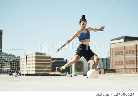 Soccer player, woman and soccer ball kick in fitness, training or exercise on Portugal city building rooftop. Football player, sports person and athlete in energy workout for health or wellness goals Soccer player, woman and soccer ball kick in fitness, training or exercise on Portugal city building rooftop. Football player, sports person and athlete in energy workout for health or wellness goals 124500524