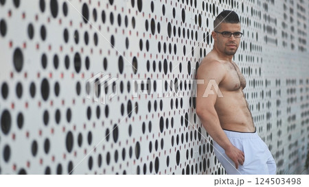 Muscular young man Arab posing against white background. Muscular young man Arab posing against white background. 124503498