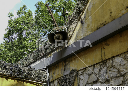 Vietnam, Hanoi, Entrance to Hoa Lo Prison or Central House. Walls with barbed wire and loudspeaker Vietnam, Hanoi, Entrance to Hoa Lo Prison or Central House. Walls with barbed wire and loudspeaker 124504315
