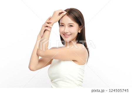 A beautiful young Asian woman with clean, fresh skin against a white background. Skincare, facial treatment, cosmetology, beauty, and spa. An elegant portrait of an Asian woman. A beautiful young Asian woman with clean, fresh skin against a white background. Skincare, facial treatment, cosmetology, beauty, and spa. An elegant portrait of an Asian woman. 124505745