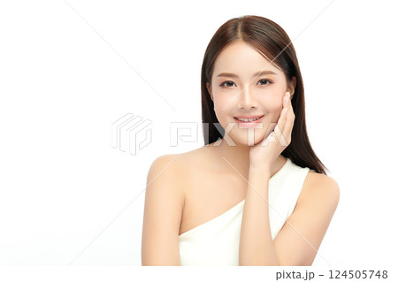 A beautiful young Asian woman with clean, fresh skin against a white background. Skincare, facial treatment, cosmetology, beauty, and spa. An elegant portrait of an Asian woman. 124505748